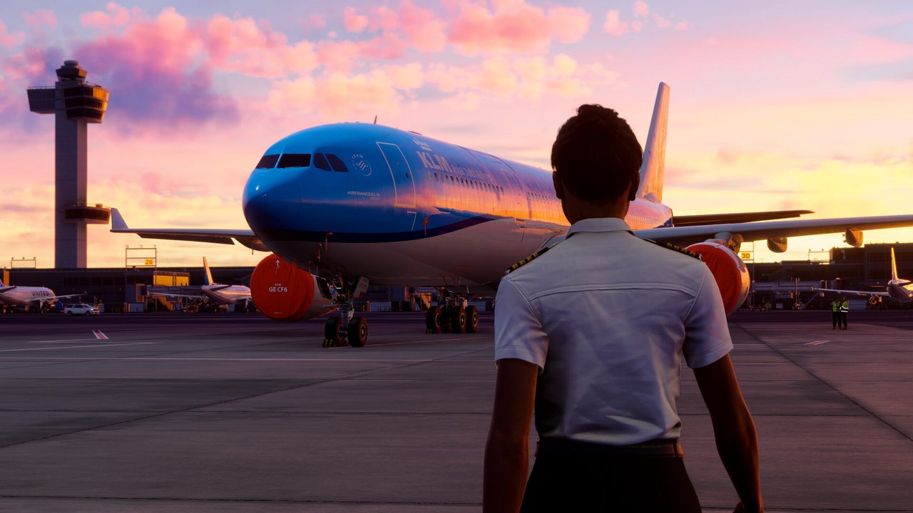 A pilot walking out to an airliner at sunset