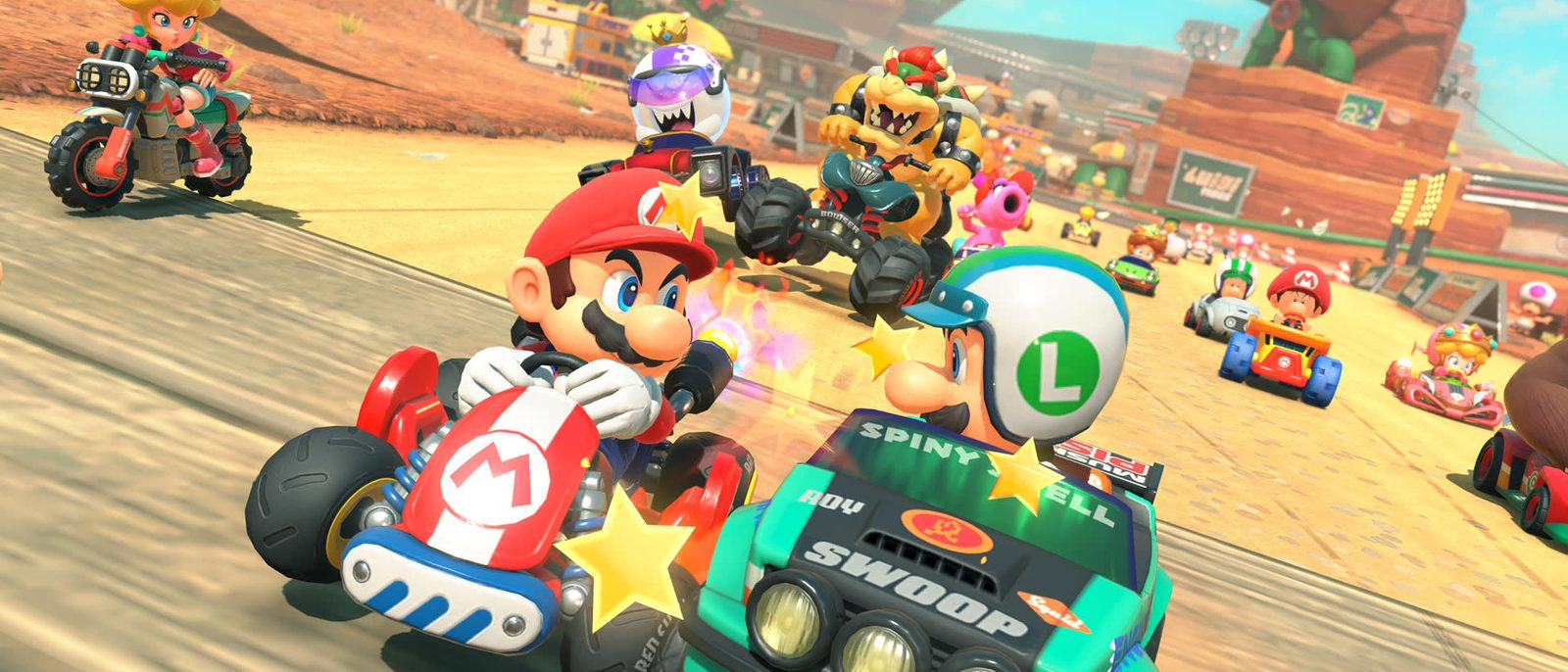 Mario and Luigi racing side by side on a sunlit desert track