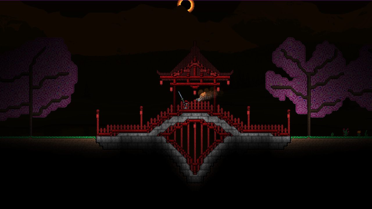 A red pagoda bridge built across a dark night landscape