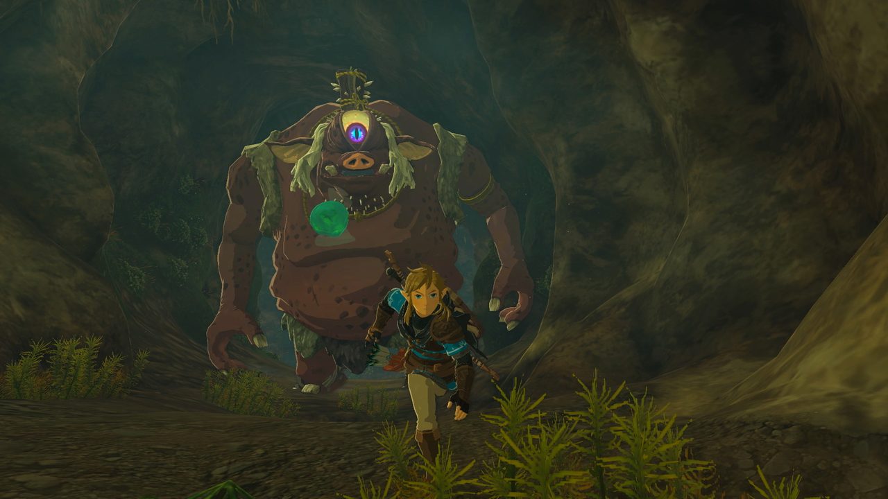 Link running from a cyclops giant through a dark cave